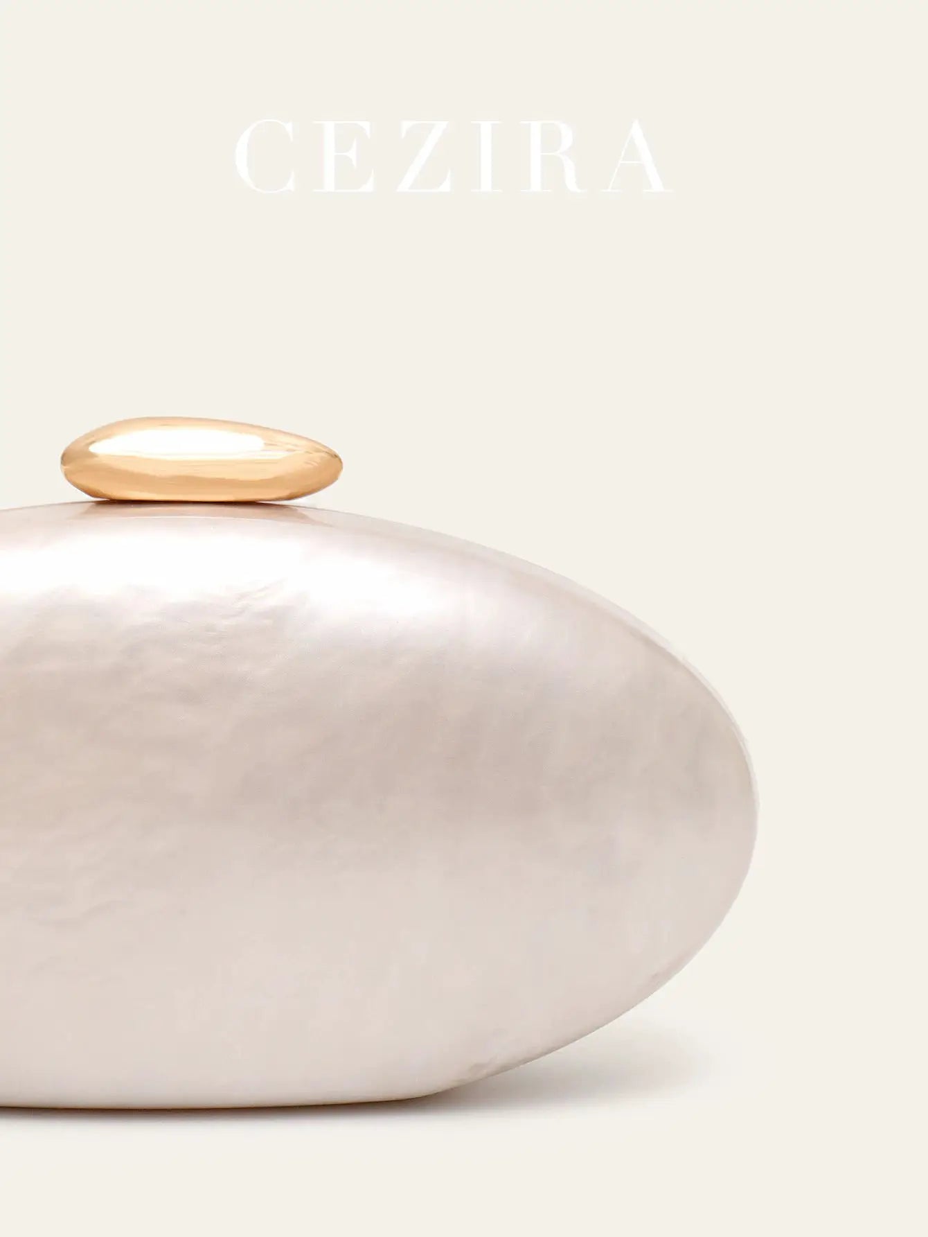 Oval acrylic evening clutch by Simples Market with gold top clasp, pearl-white finish