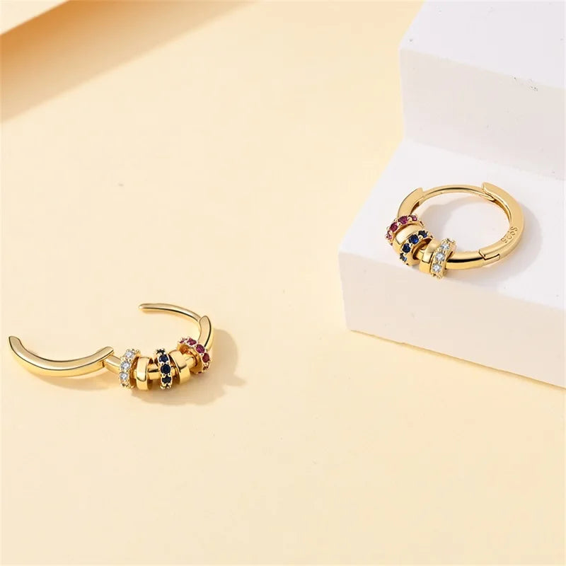 Gold-tone hoop earrings with multicolored gemstone and crystal spacers; pair shown