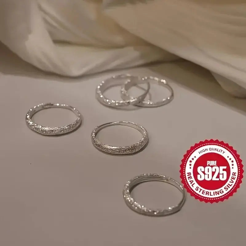 Five silver-tone frosted circle hoop earrings by Simples Market, S925 sterling silver.