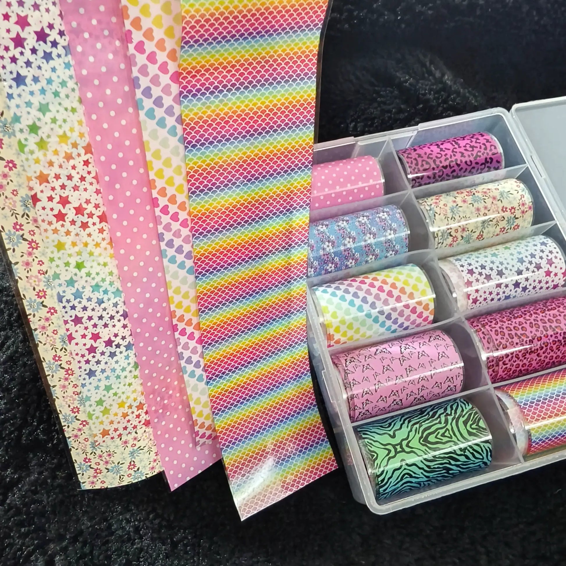Nail foil rolls set (10 rolls) with colorful patterns including stars, dots, hearts, scales and animal prints for nail art