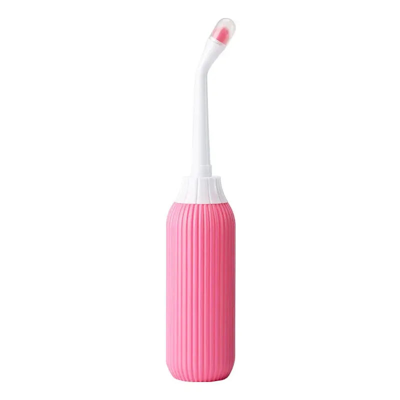 Simples Market portable bidet bottle, pink ribbed plastic with white curved nozzle