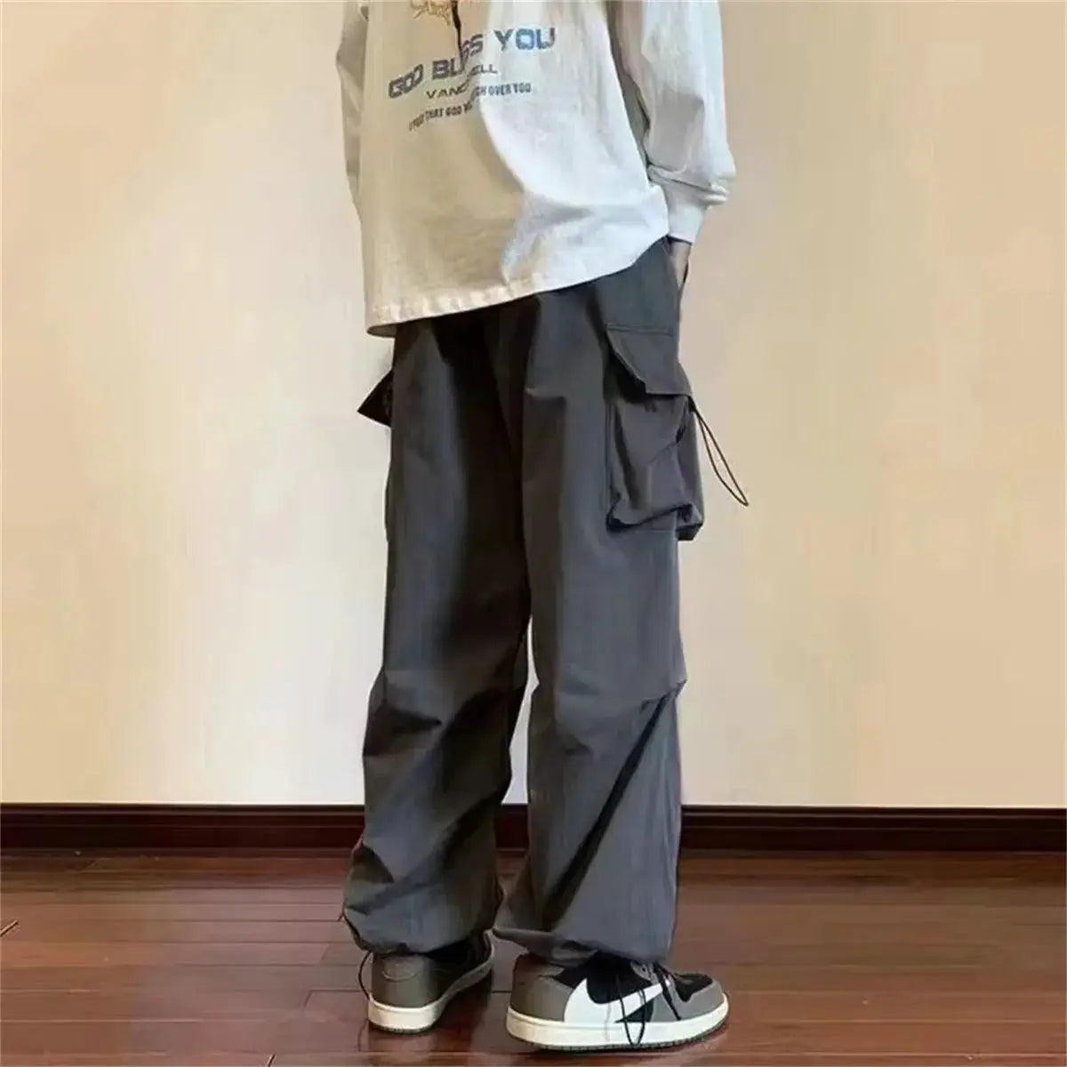 Harem cargo pants in charcoal gray with elastic waist, multiple pockets, loose baggy fit