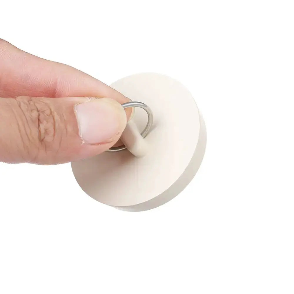 Simples Market white rubber sink plug with metal pull ring.