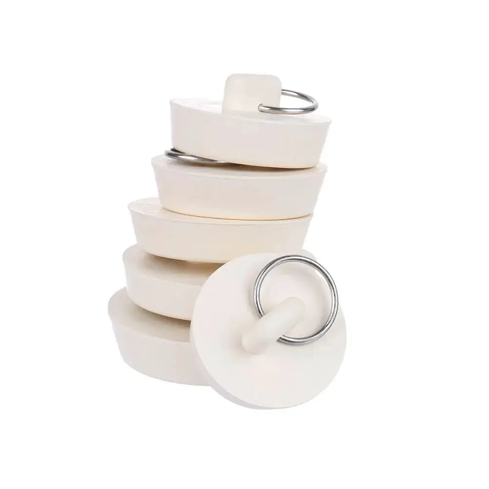 Six white rubber sink drain plugs with metal rings
