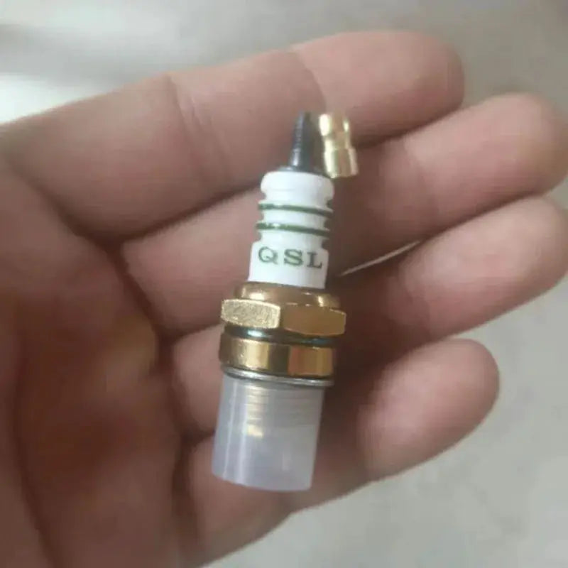 BM6A spark plug for small engines by Simples Market; white ceramic body with brass hex nut