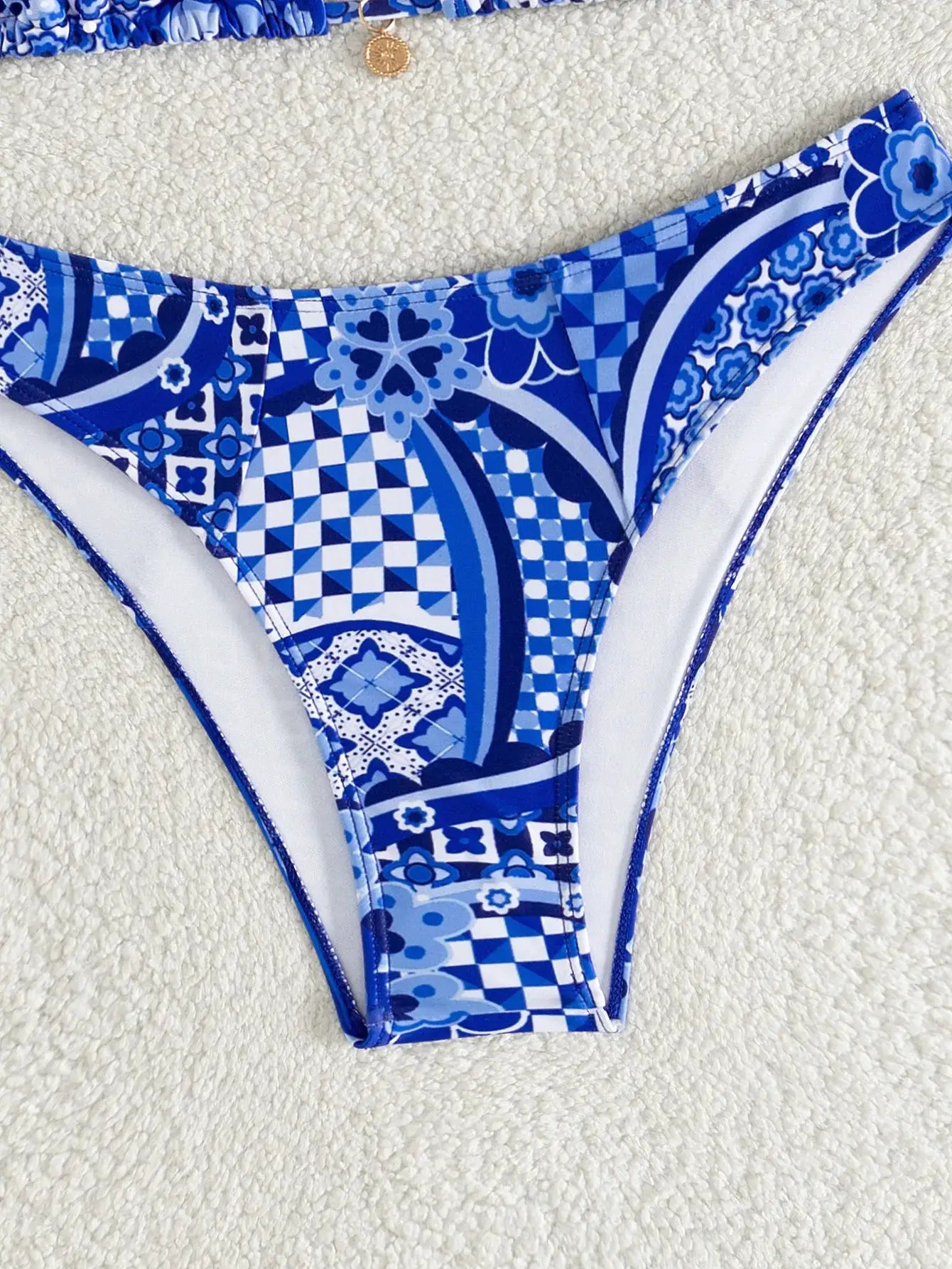 Triangle bikini set in blue floral print; Brazilian-cut bottom.