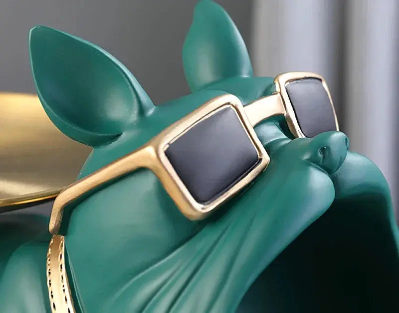 Resin bulldog statue storage tray in teal with gold-framed sunglasses.