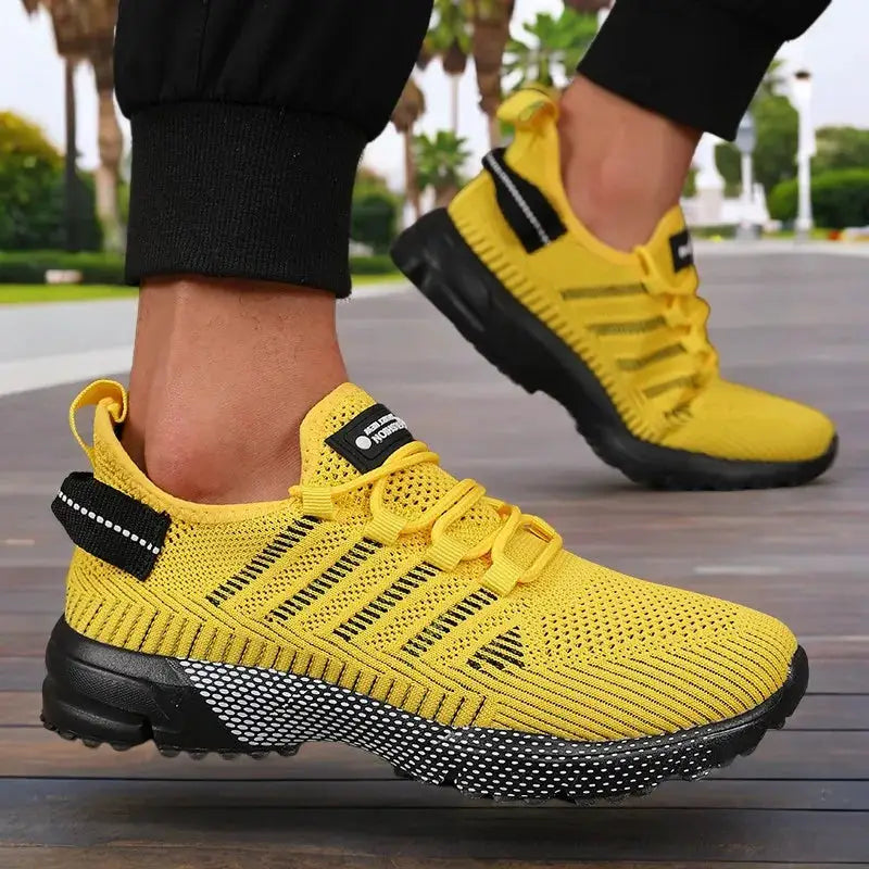 Pair of Simples Market men's yellow knit sneakers with thick black sole and breathable lightweight design