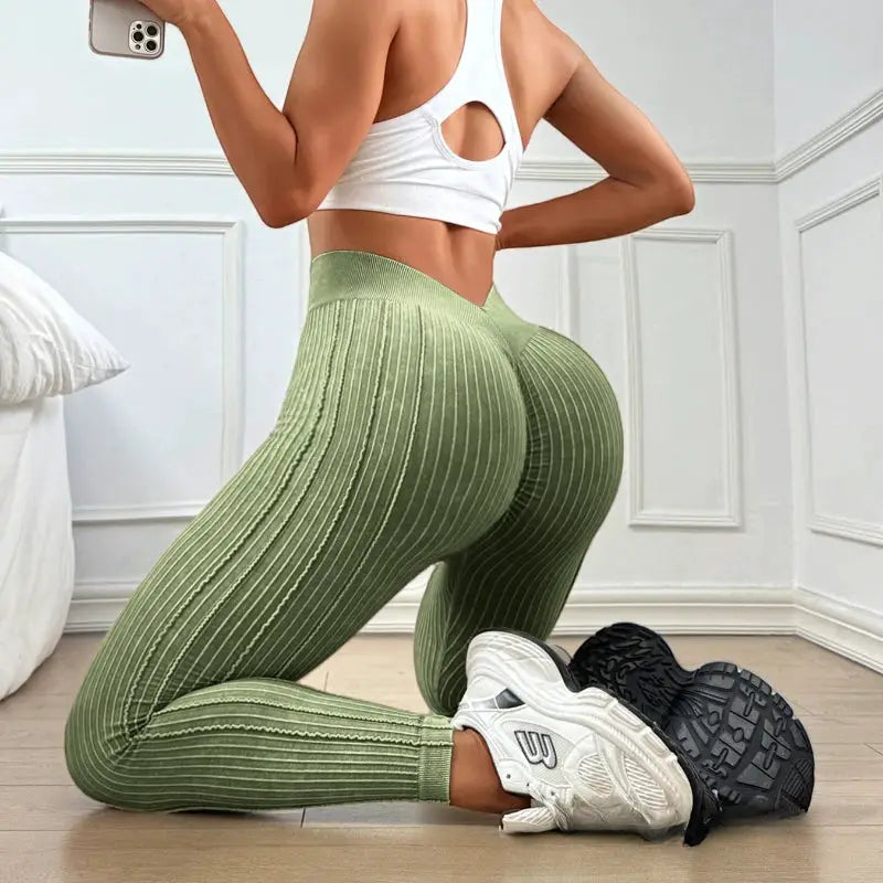 Womens olive green ribbed high-waisted yoga leggings with vertical stripes for workouts