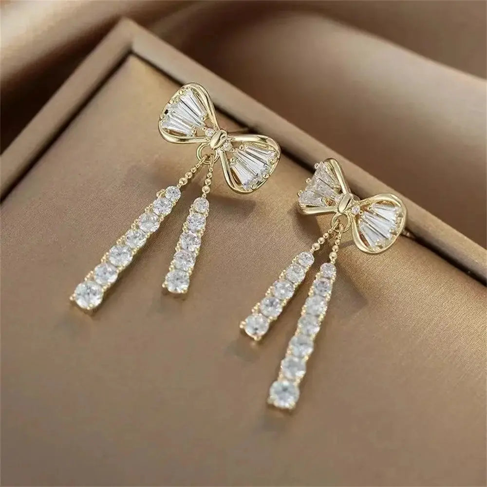 Fashion Bow Crystal Zircon Earrings by Simples Market, gold-tone with dangling crystal strands