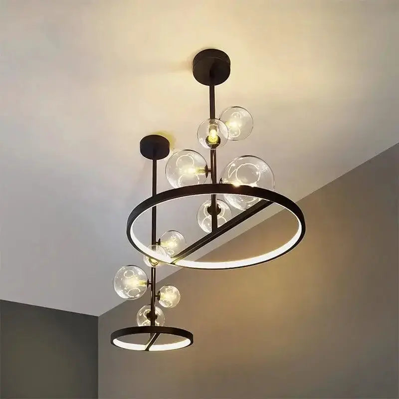 Modern art glass chandelier with black metal rings and clear glass globe bulbs for contemporary ceiling lighting