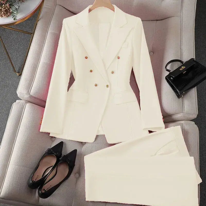 Cream two-piece blazer and trousers set for women; double-breasted with gold buttons.
