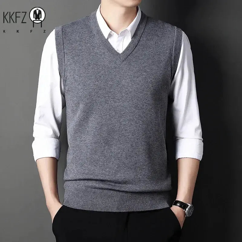 Men's gray V-neck knitted vest layered over white shirt; KKFZ logo visible
