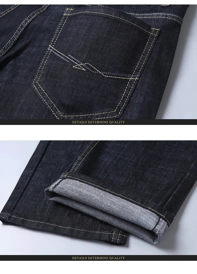 Men's dark blue denim jeans with back pocket stitching and rolled cuffs.