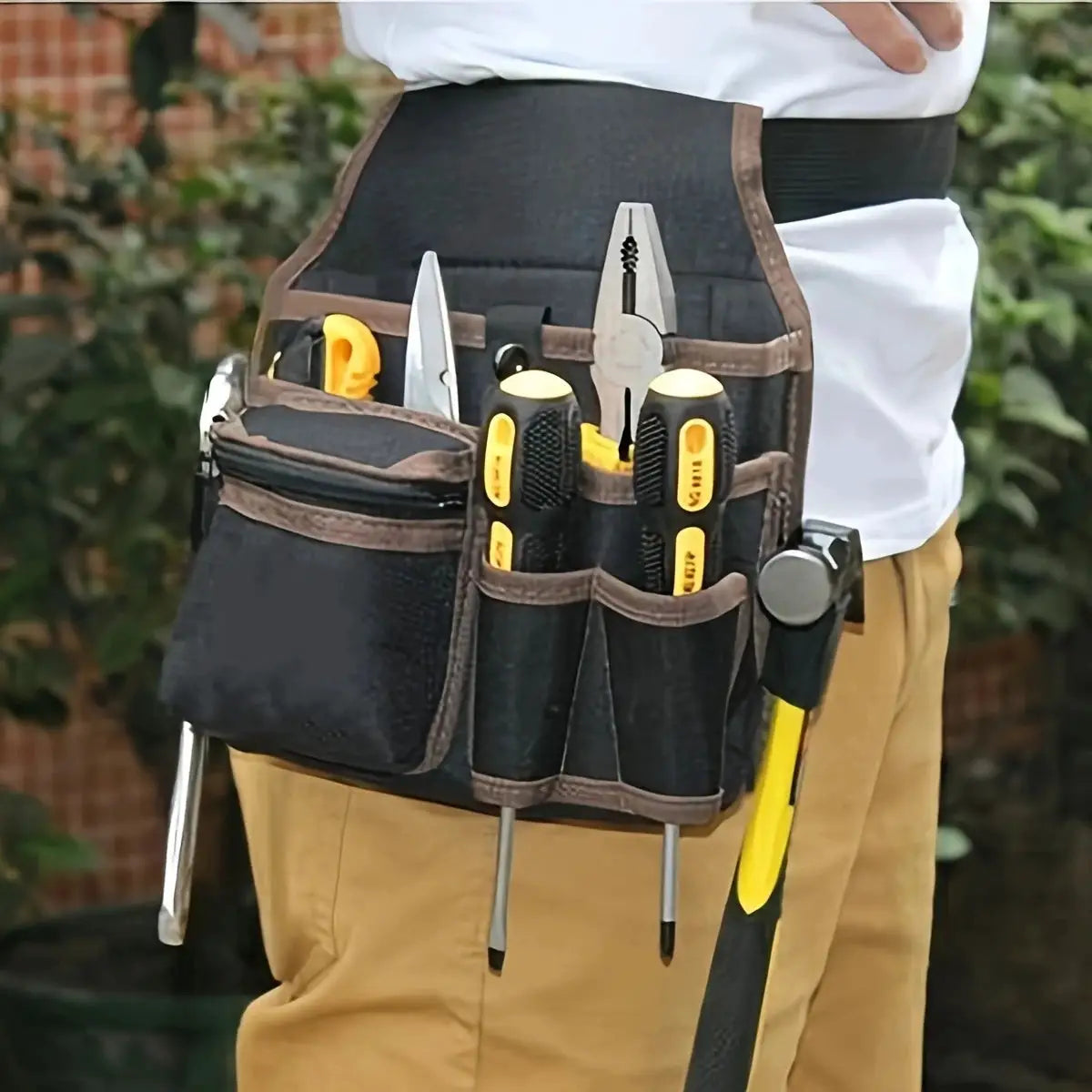 Electrician's waist-hanging tool bag with black and brown trim, holding yellow-handled screwdrivers, pliers, scissors.