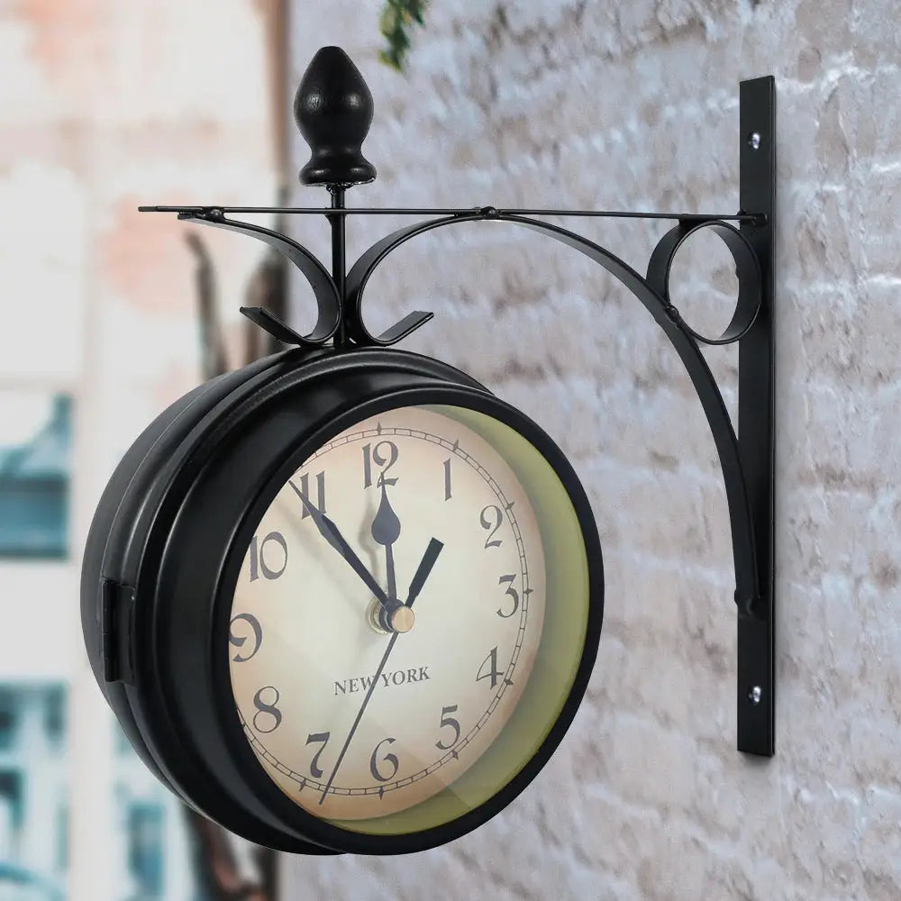 Double-sided wall clock, black metal with a decorative wall bracket; cream dial with black numerals and New York text.