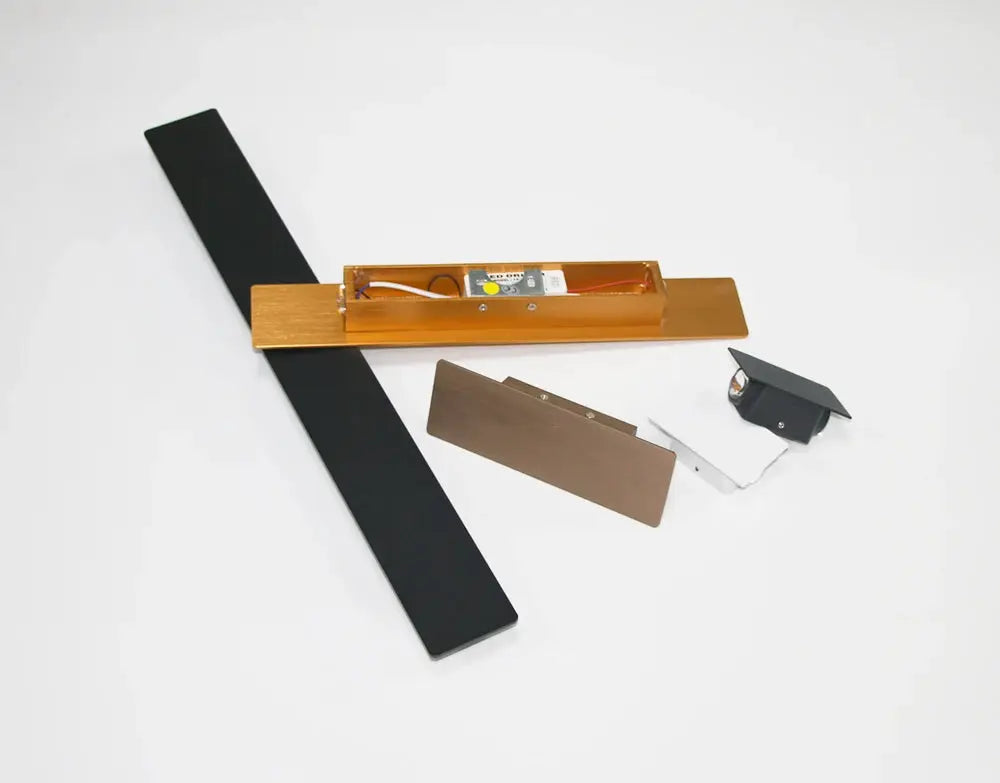 Modern LED indoor wall lamp kit with gold aluminum housing and long black panel, mounting hardware included