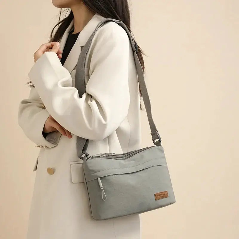 Shoulder crossbody bag by Simples Market in light gray canvas with 3 main pockets