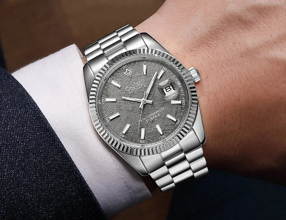 CADISEN men's stainless steel automatic watch with grey textured dial, fluted bezel, luminous markers, and date window.