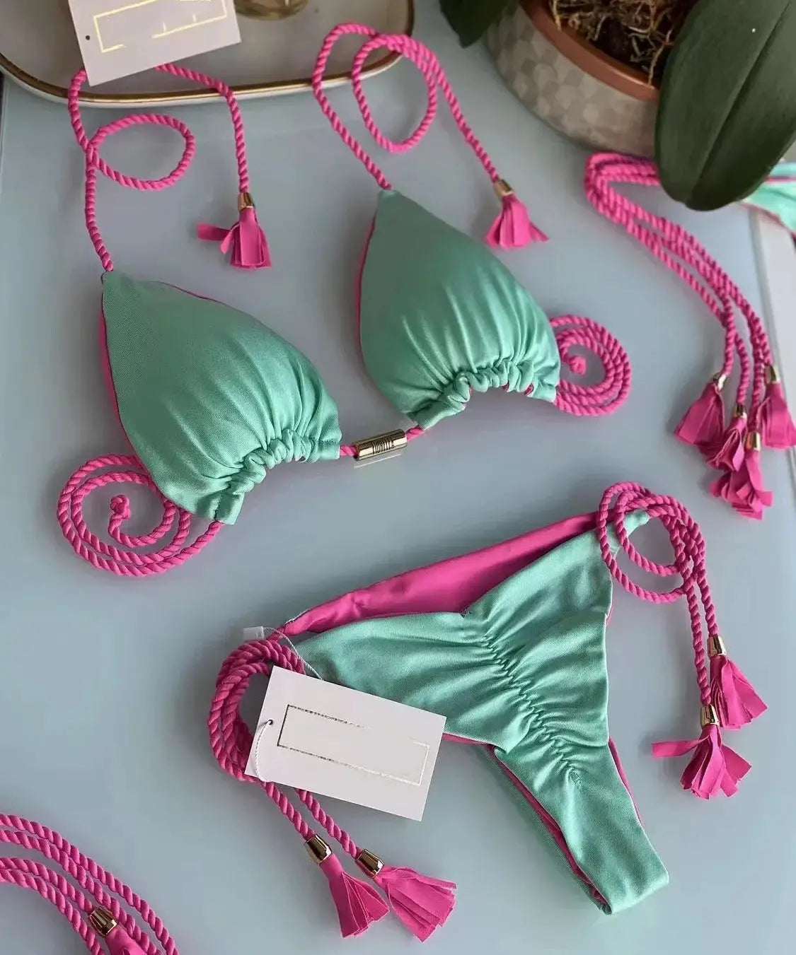 Two-piece women bikini set with backless rope triangle top, mint green cups and pink tassel ropes