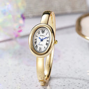 Gold-tone wristwatch for women by XIMILI with oval dial, Roman numerals and blue hands