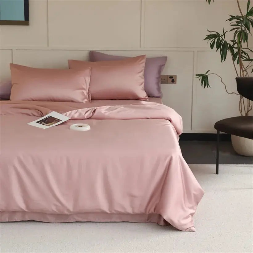 Mulberry silk bedding set in soft pink with duvet cover, sheets and pillowcases on bed