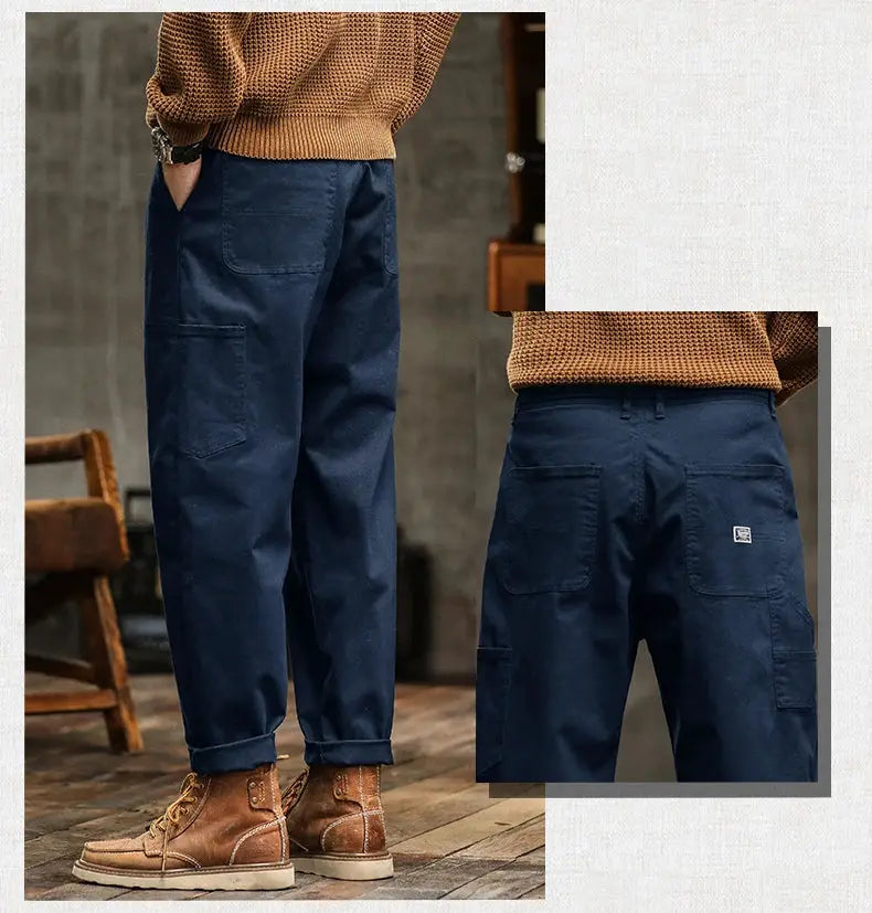 Men's navy cotton cargo pants with a loose straight fit, mid waist, and multiple cargo pockets.