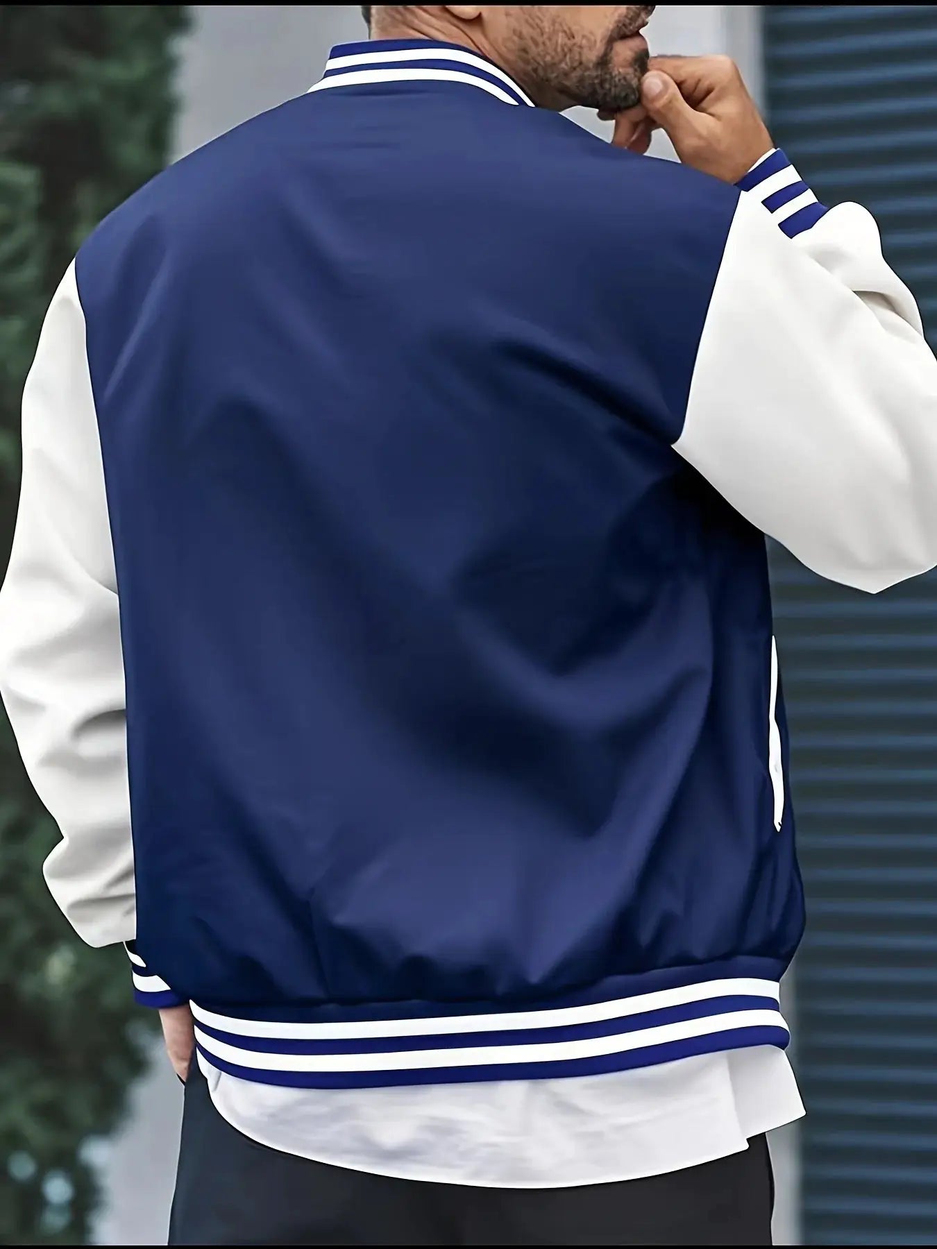 Men's navy blue and white varsity jacket with striped collar and cuffs, back view