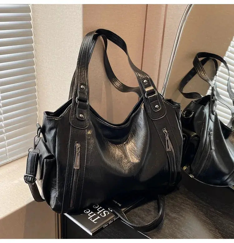 Simples Market black PU leather shoulder bag with soft interior, top handles, and front zip pockets.
