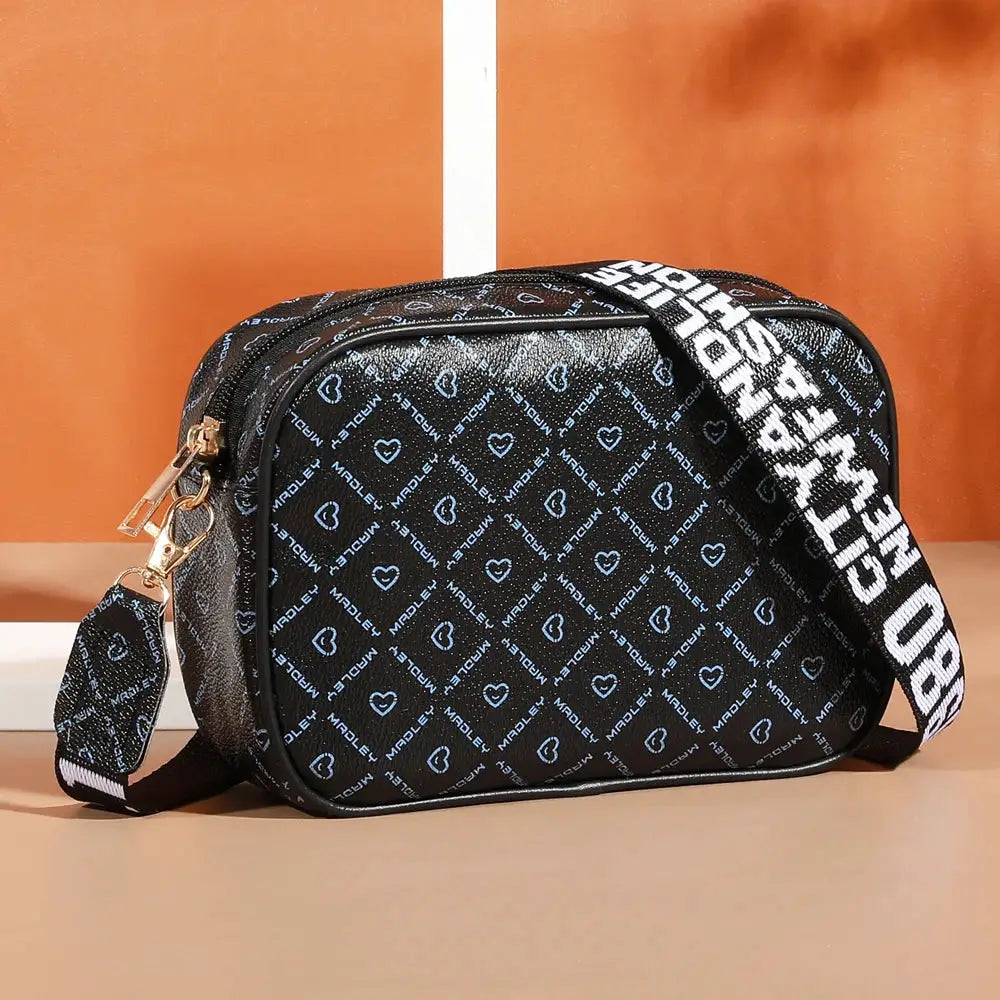 Crossbody bag by Simples Market, black with blue heart pattern and adjustable strap