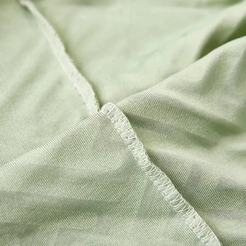 Sofa cushion cover Simples Market in light green stretch fabric with overlock seam.