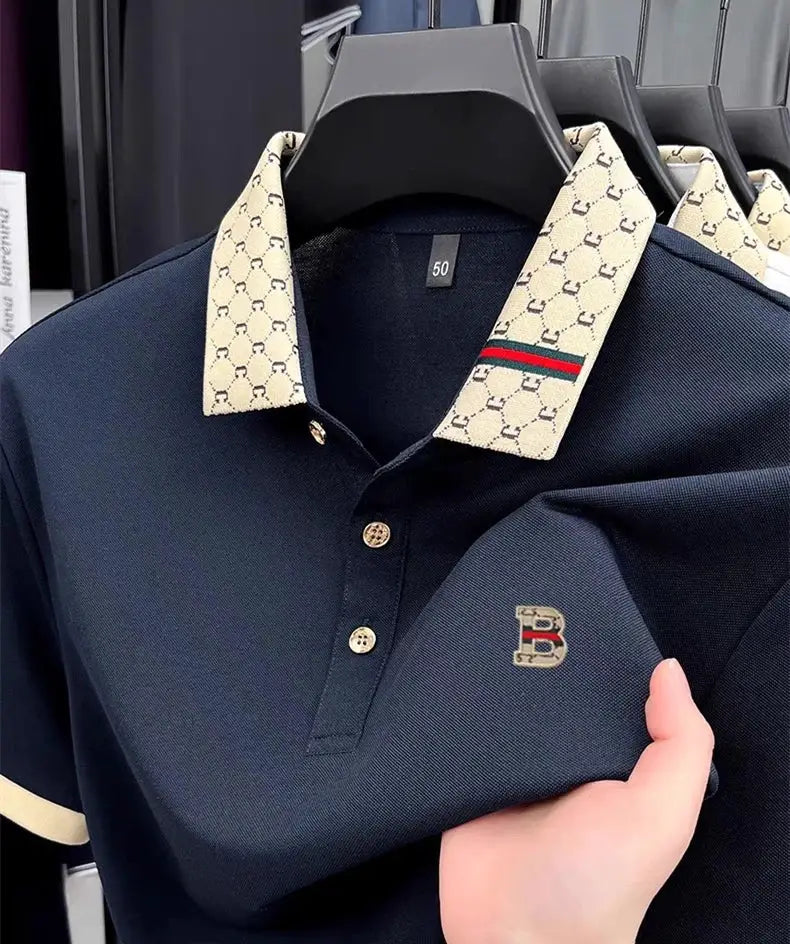 Short-sleeve polo shirt, navy with beige check-pattern collar, gold buttons, and B logo embroidery on chest