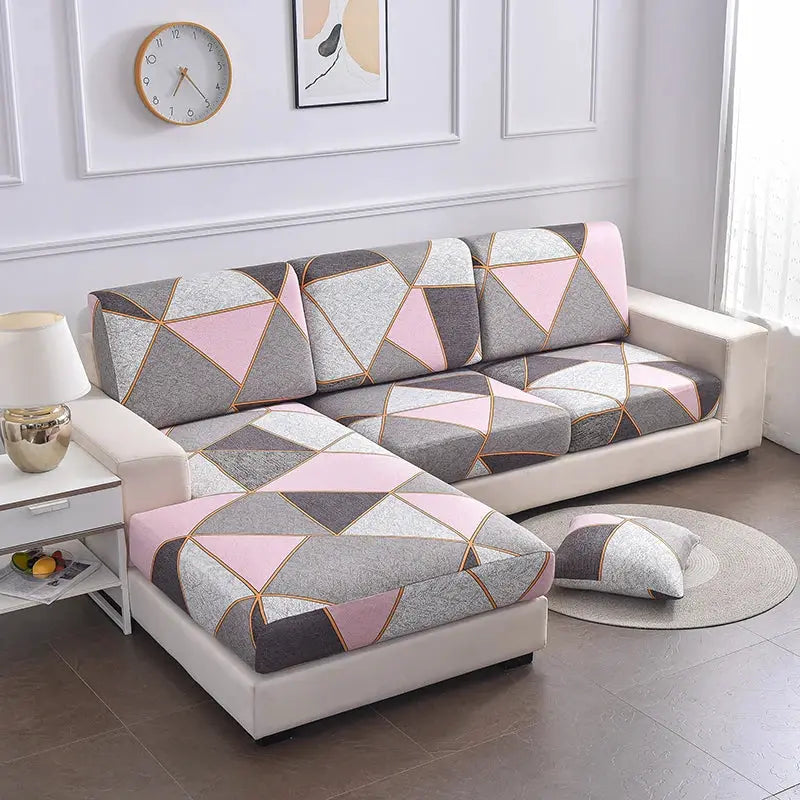 Elastic seat cushion cover for sofa in pink and gray geometric pattern; washable and removable.