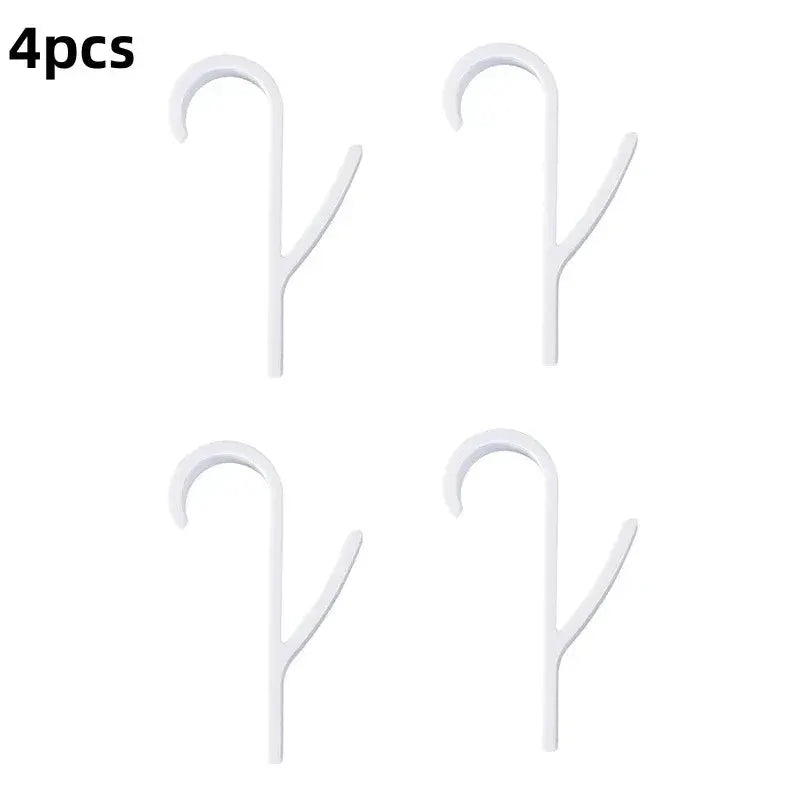 Set of four white Y-shaped bathroom towel hooks for hanging towels