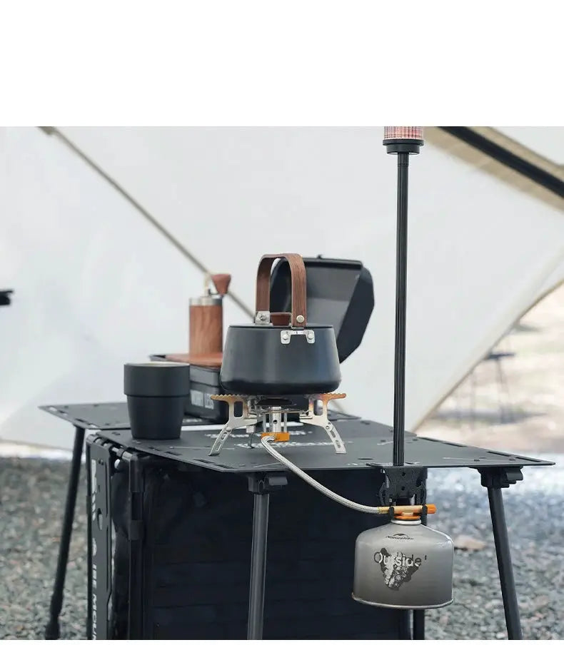 Gas canister hook with hanging plate and bottle opener; grey metal shown with camping stove on a portable table.