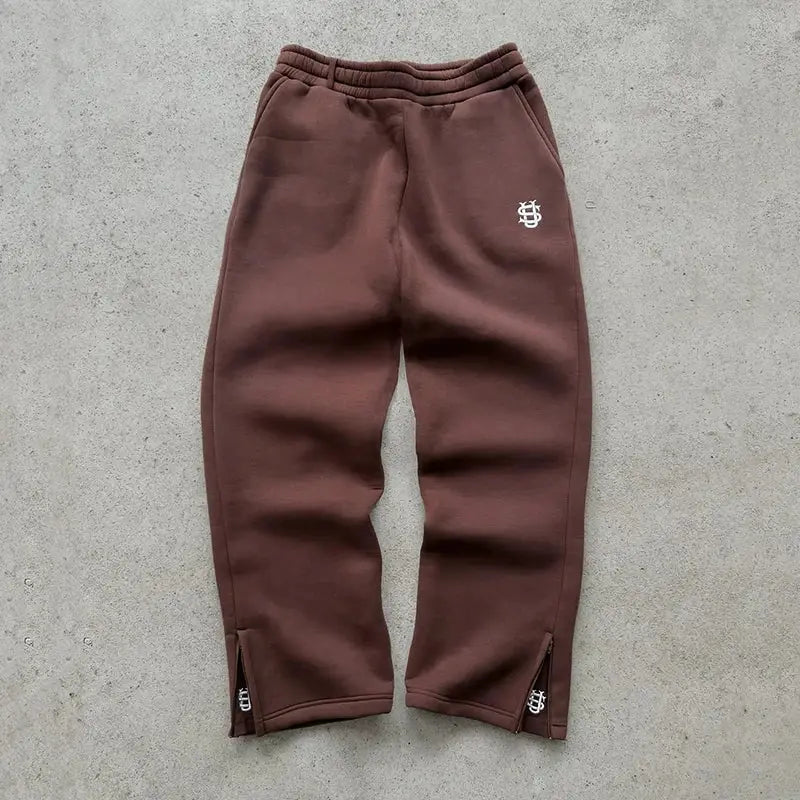Brown Simples Market jogger sweatpants with elastic waist and zip cuffs; white thigh logo