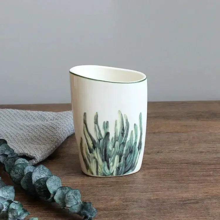 White ceramic bathroom tumbler with green cactus motif