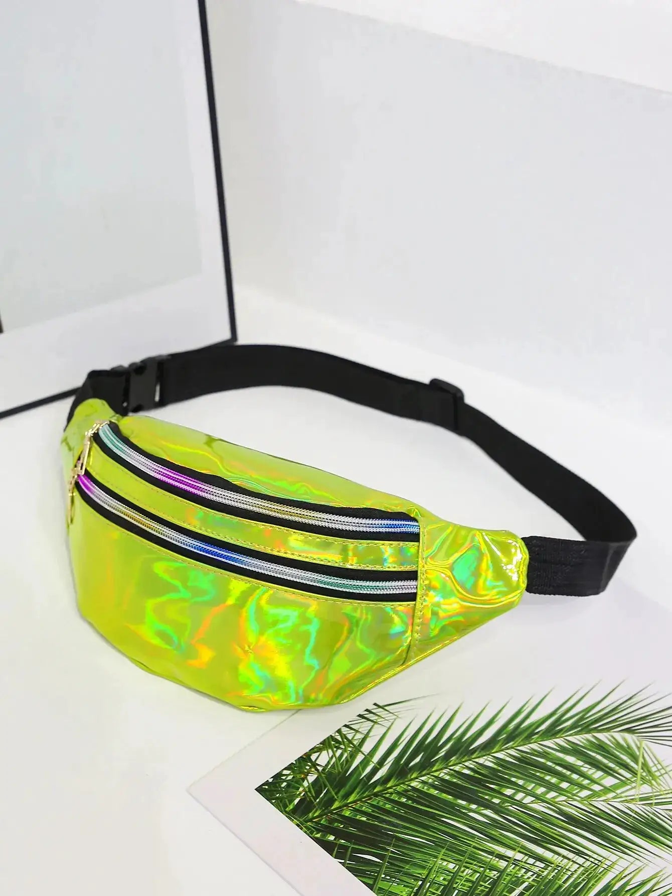 Holographic waist bag by Simples Market with neon iridescent material and black adjustable strap.
