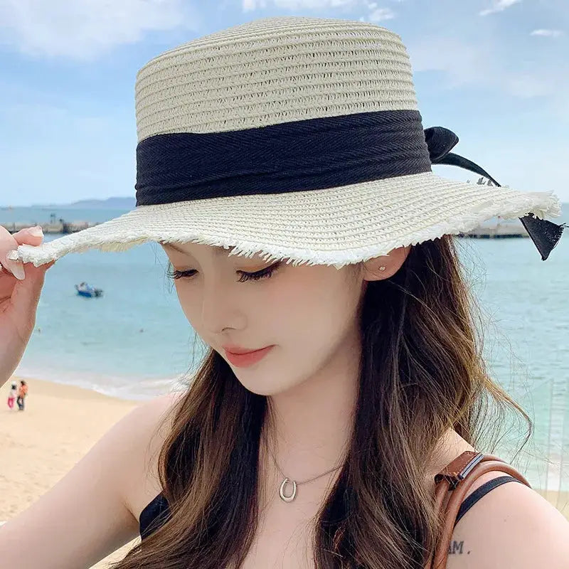 Korean bow straw hat for women with a wide beige brim and black ribbon, beach sun visor style