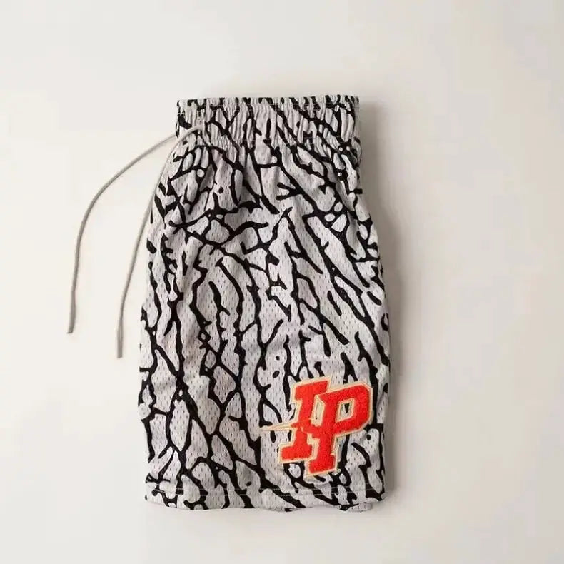 Men's IP Trend quick-dry mesh shorts with light gray base and black abstract pattern, orange IP logo patch.