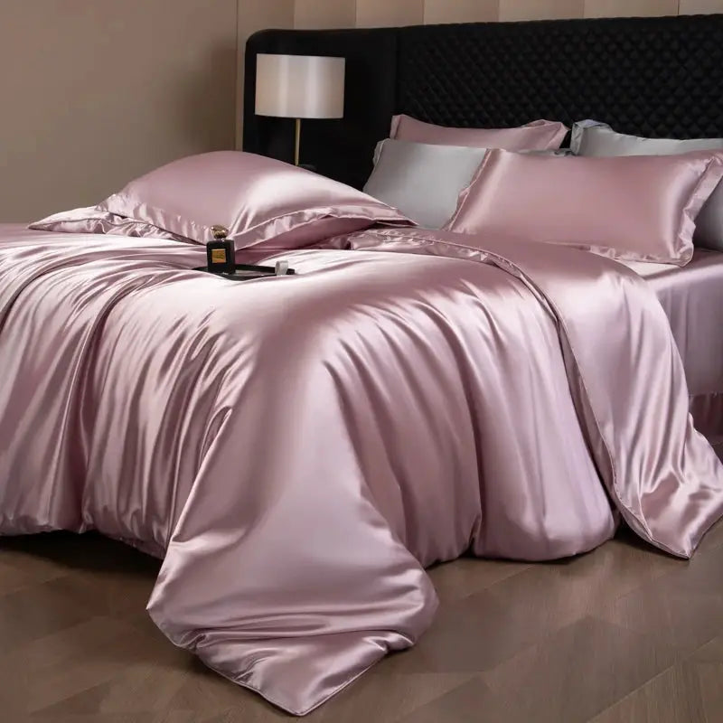 Silk bed sheets set in pink with duvet cover, fitted and flat sheets, and pillowcases