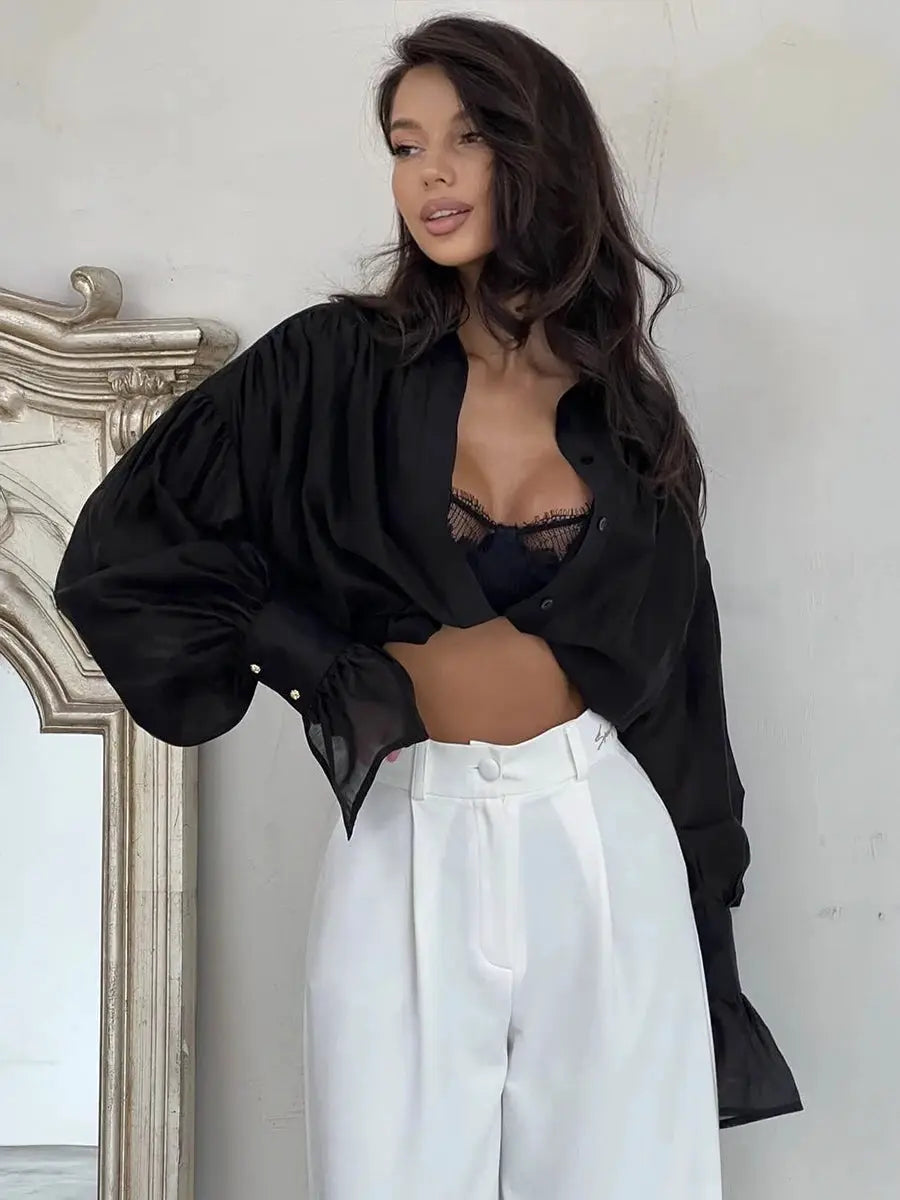 Bornladies black collared shirt with flare sleeves, paired with white high-waisted trousers