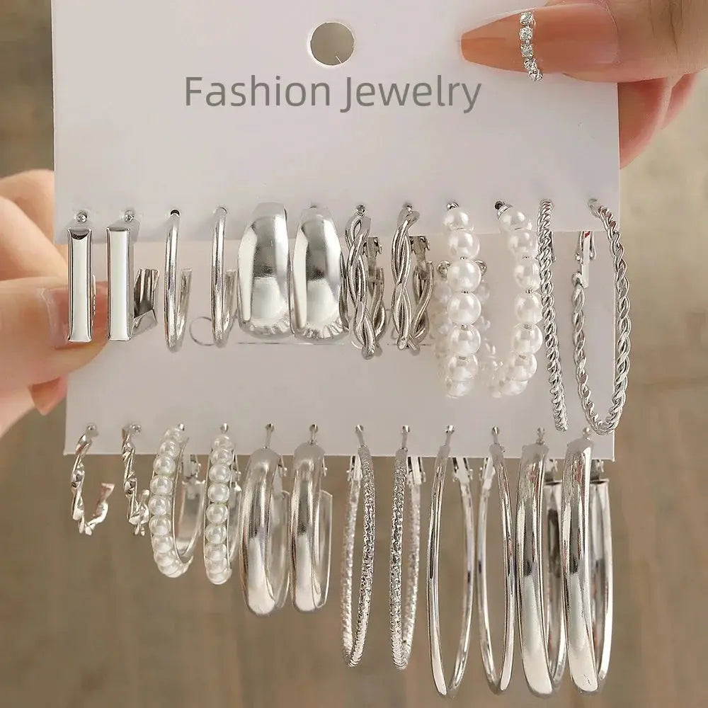 Set of silver hoop earrings with pearl accents on display card