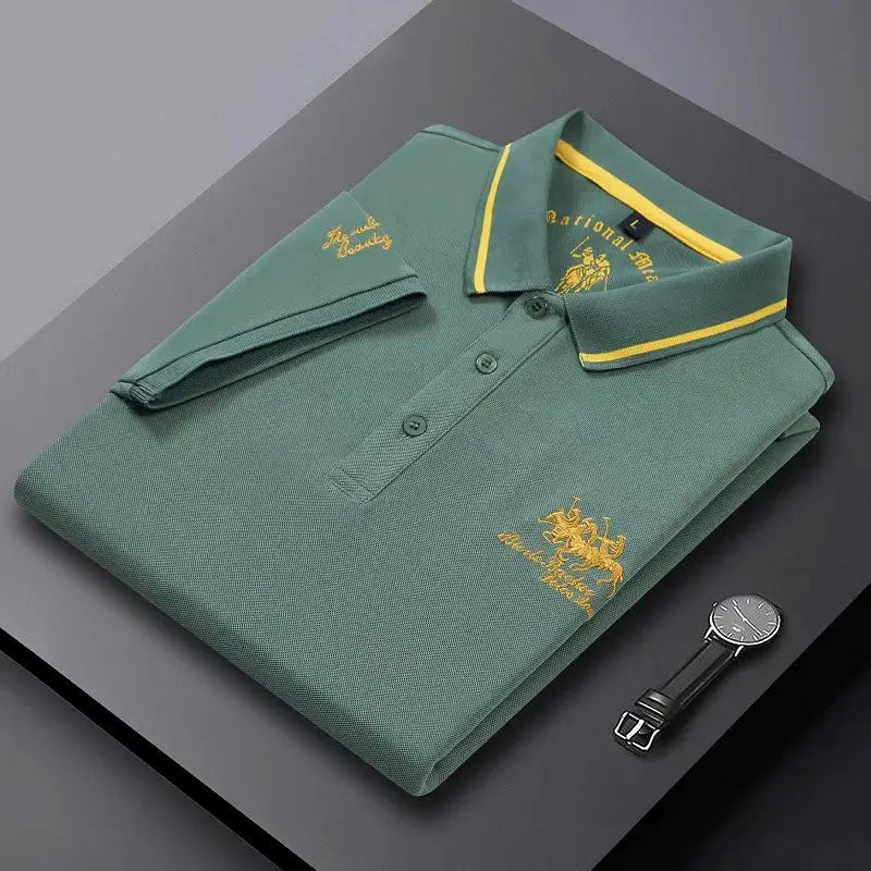 Men's green polo shirt with yellow collar trim and gold crest embroidery; breathable lightweight fabric.