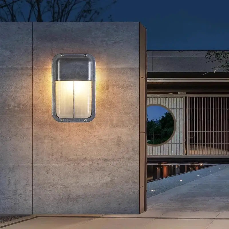 Outdoor retro LED wall lamp with a metal gray frame and glass diffuser, IP65 waterproof for garden or porch.