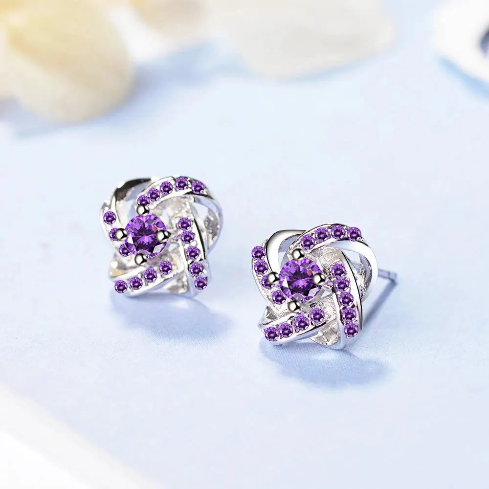 Sterling silver Eternal Heart Twist earrings with purple zirconia stones, pair