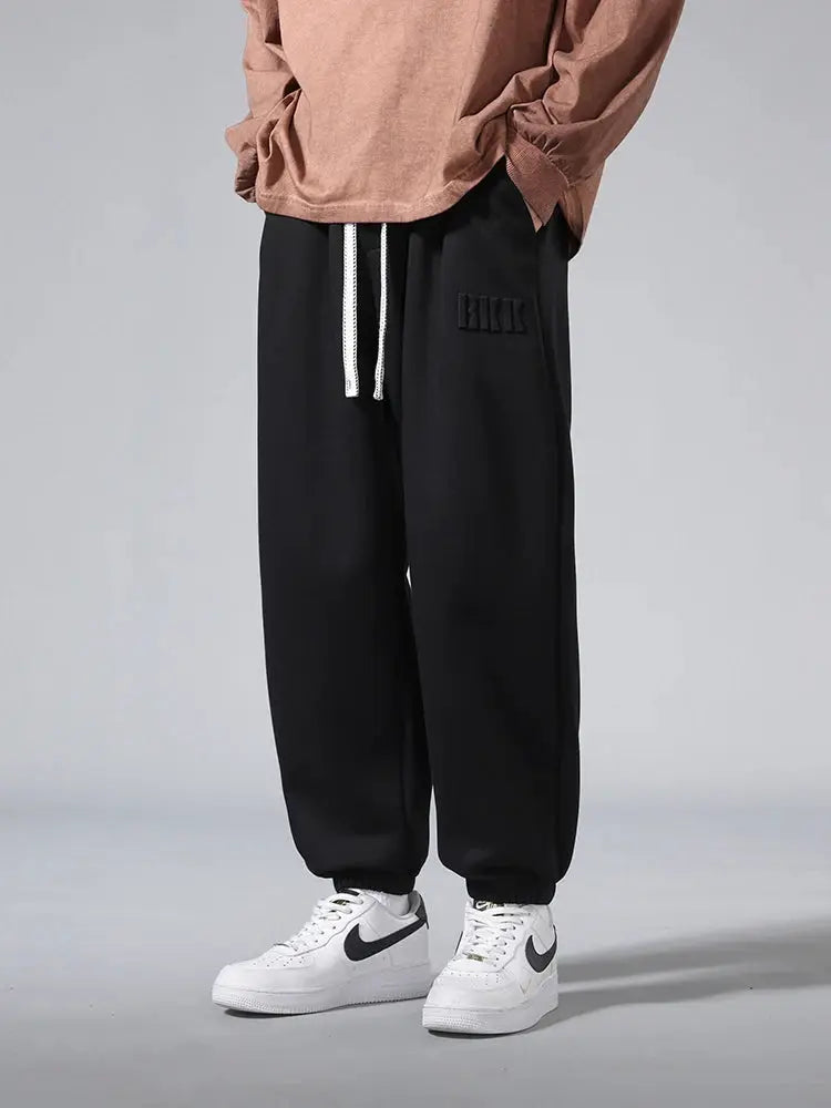 Men's black cotton-polyester joggers with white drawstring, baggy hip-hop style by Simples Market.