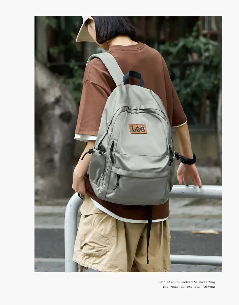 Lee lightweight gray 16-inch laptop backpack in Oxford fabric with front pockets and logo patch