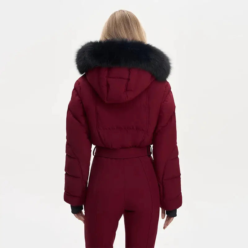 Ski jumpsuit for women in burgundy with faux fur hood and waist belt, back view