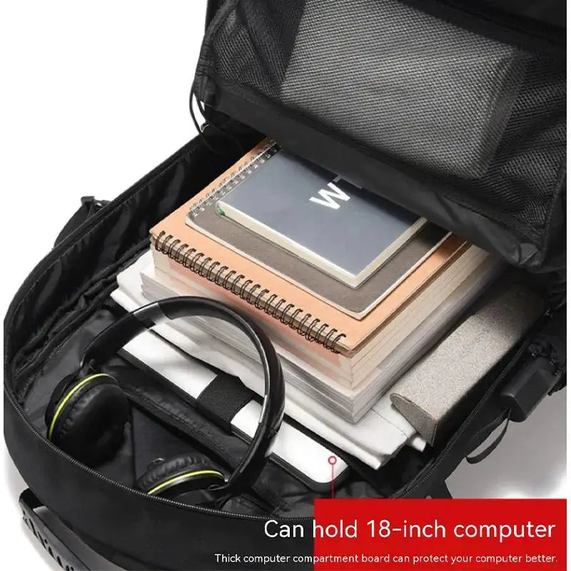 Interior view of a large capacity travel backpack with books, headphones, and a computer compartment.